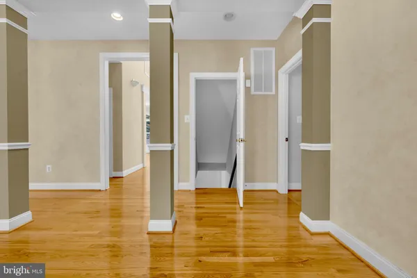a view of a hallway with wooden floor