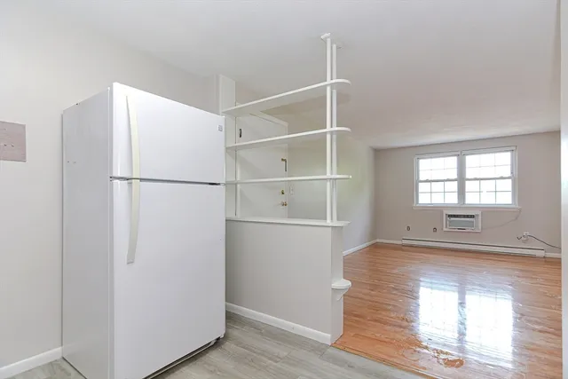 a view of a closet with wooden floor