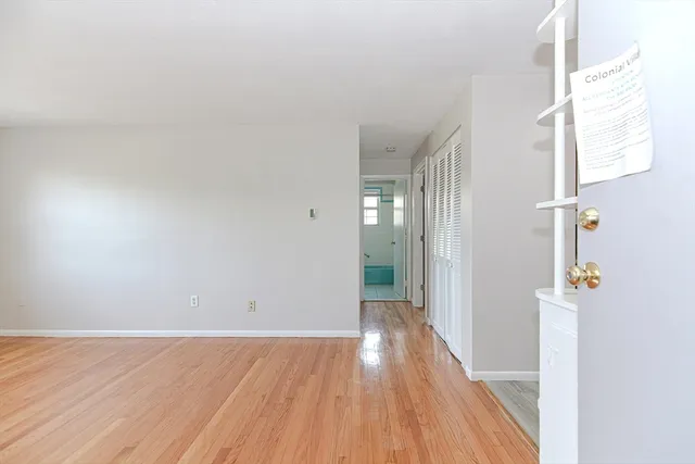 a view of a room with wooden floor and a window