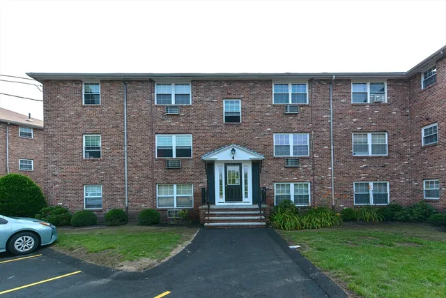 a view of a brick building next to a yard