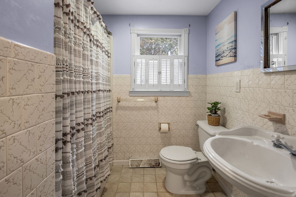30 Mayflower Road Eastham, MA 02642 - Photo 13 of 38 a white toilet sitting next to a bathroom sink