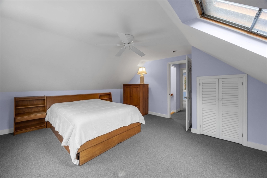 30 Mayflower Road Eastham, MA 02642 - Photo 21 of 38 a spacious bedroom with a bed and a chandelier