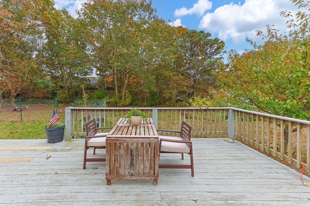 30 Mayflower Road Eastham, MA 02642 - Photo 29 of 38 a view of a balcony with two chairs and wooden floor