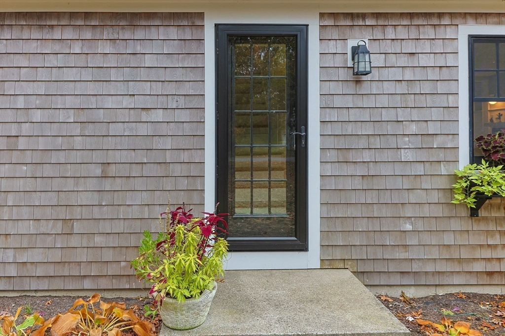 30 Mayflower Road Eastham, MA 02642 - Photo 4 of 38 a front view of a house with a potted plant