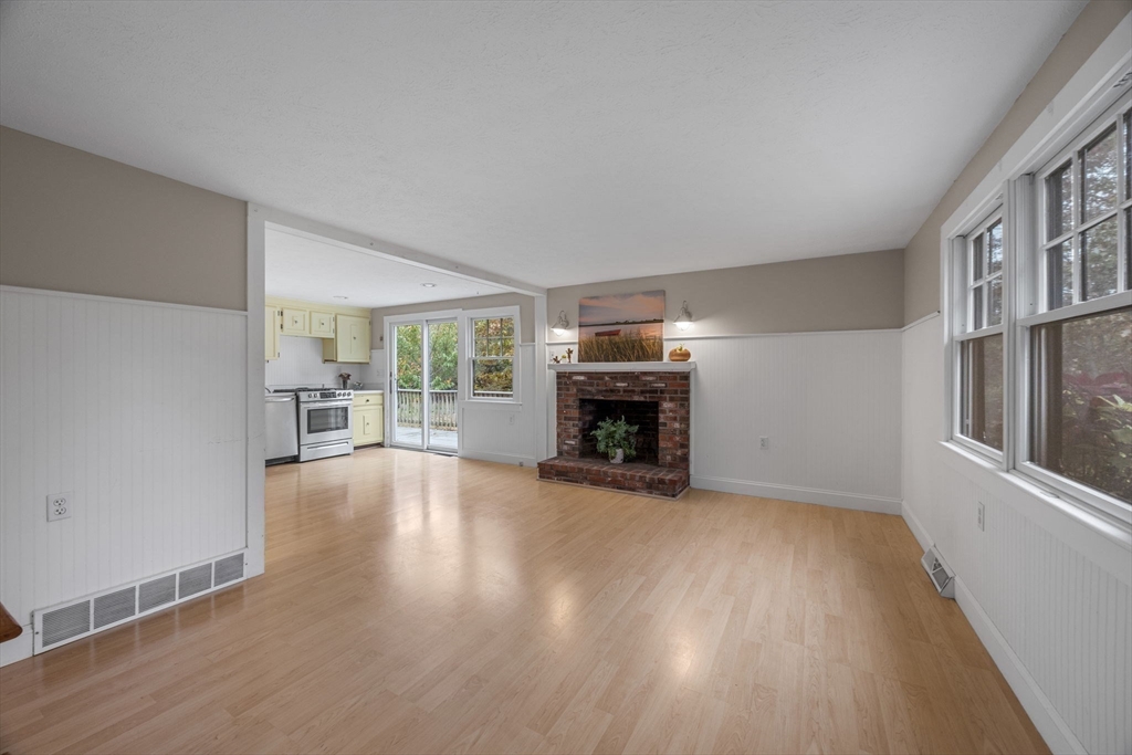 30 Mayflower Road Eastham, MA 02642 - Photo 6 of 38 a view of empty room with fireplace and wooden floor