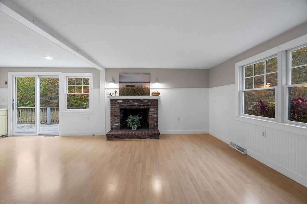 30 Mayflower Road Eastham, MA 02642 - Photo 7 of 38 a view of an empty room with a window and fireplace