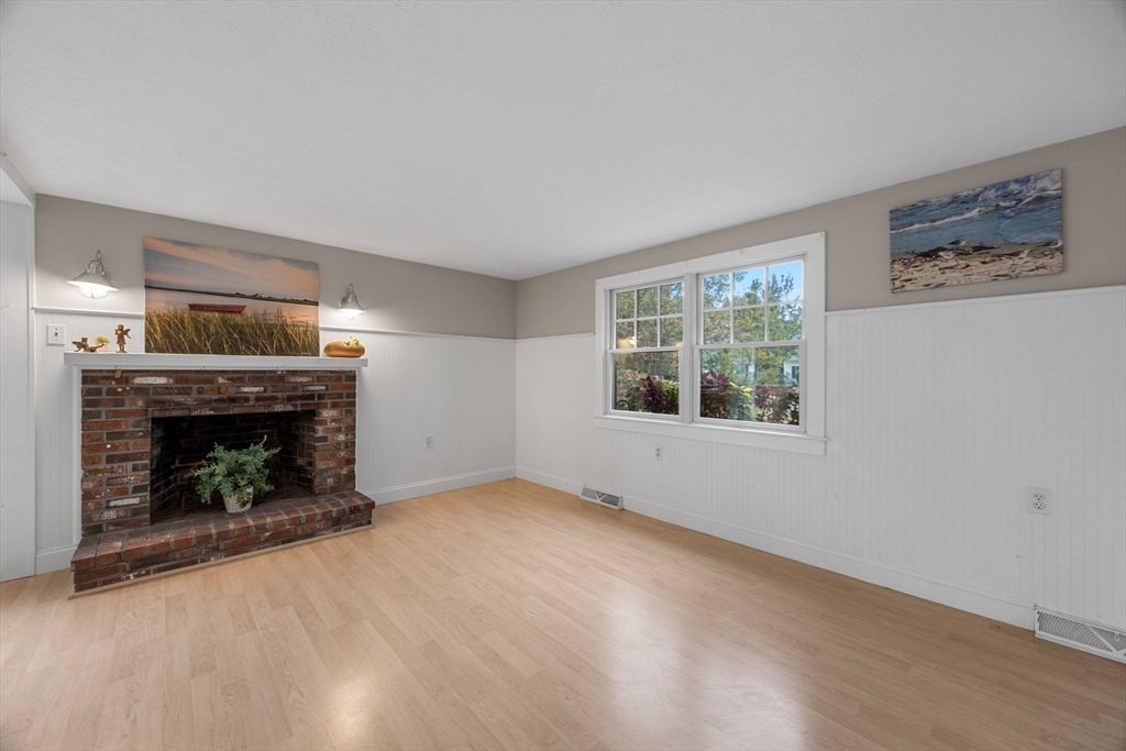 30 Mayflower Road Eastham, MA 02642 - Photo 8 of 38 a view of an empty room with window and fire place