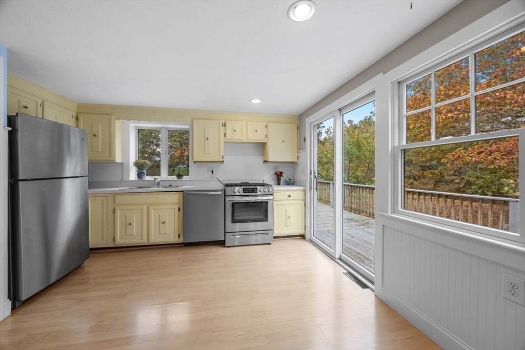 30 Mayflower Road Eastham, MA 02642 - Photo 10 of 38 a kitchen with a refrigerator a sink and cabinets