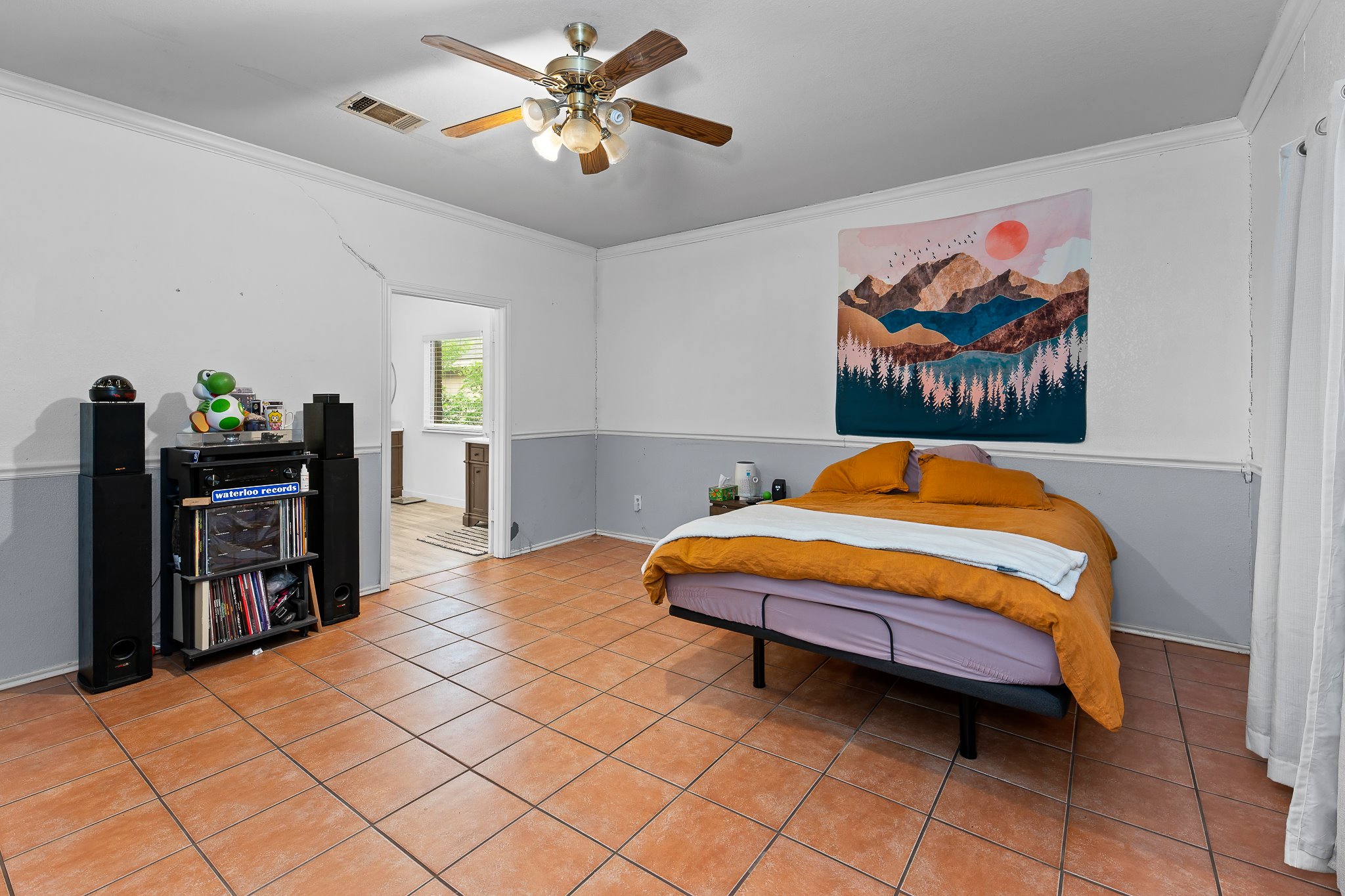 11737 Rydalwater Lane Austin, TX 78754 - Photo 17 of 40 Spacious room featuring square tile flooring, a ceiling fan with integrated lighting, and a two-tone wall finish
