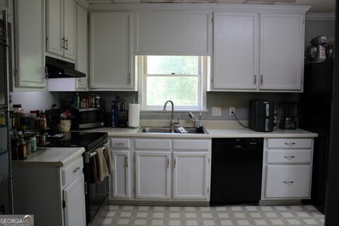 302 James Place Macon, GA 31220 - Photo 5 of 9 a kitchen with stainless steel appliances granite countertop a sink a stove and a microwave