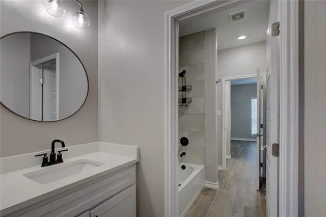 a bathroom with a sink a vanity and a mirror