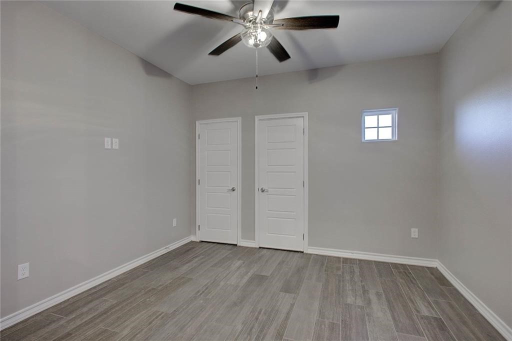 106 Peridot Street Portland, TX 78374 - Photo 12 of 17 wooden floor in an empty room with a window
