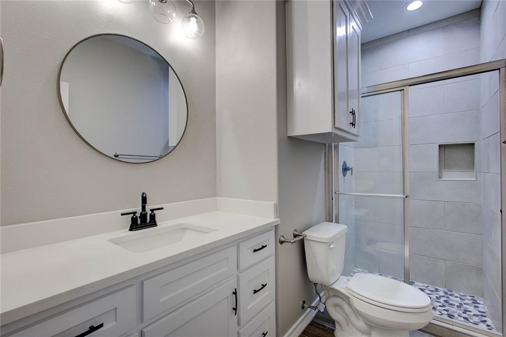 106 Peridot Street Portland, TX 78374 - Photo 14 of 17 a bathroom with a sink a toilet and a mirror