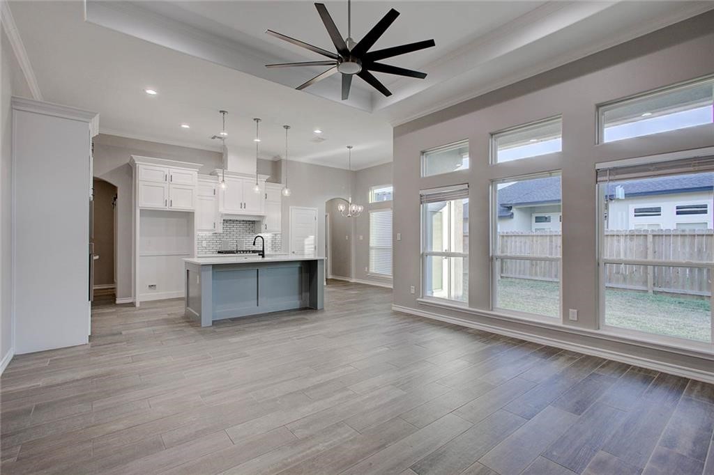 106 Peridot Street Portland, TX 78374 - Photo 2 of 17 a large kitchen with stainless steel appliances kitchen island a large counter top and a refrigerator