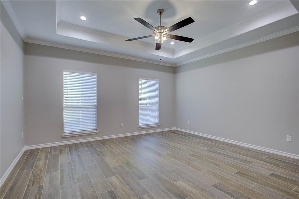 106 Peridot Street Portland, TX 78374 - Photo 6 of 17 an empty room with wooden floor and windows