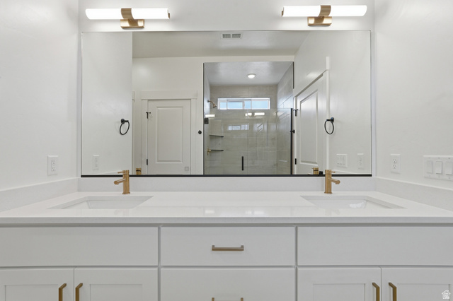 401 West 3085 South, Unit 329 Nibley, UT 84321 - Photo 32 of 34 Full bathroom featuring double vanity and a shower stall