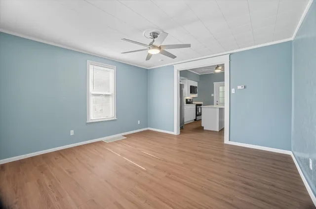 wooden floor in an empty room with a window
