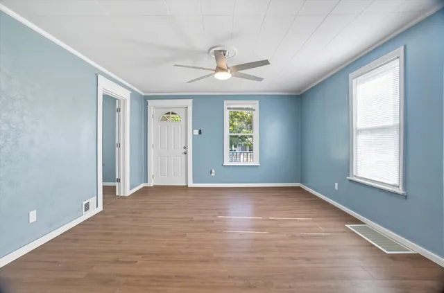 wooden floor in an empty room with a window