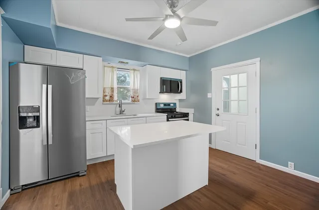 a kitchen with stainless steel appliances a refrigerator stove and sink