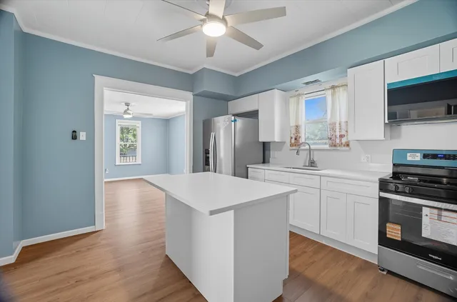 a kitchen with a stove a sink and a refrigerator
