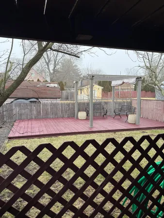 a table and chairs in front of a yard