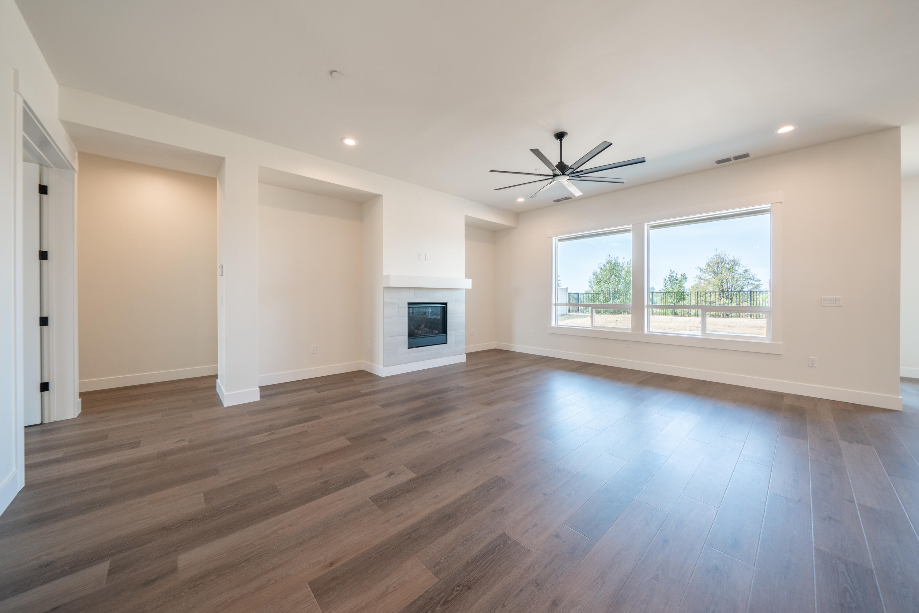 3792 Thomason Trail Redding, CA 96002 - Photo 6 of 42 a view of an empty room with wooden floor and a window