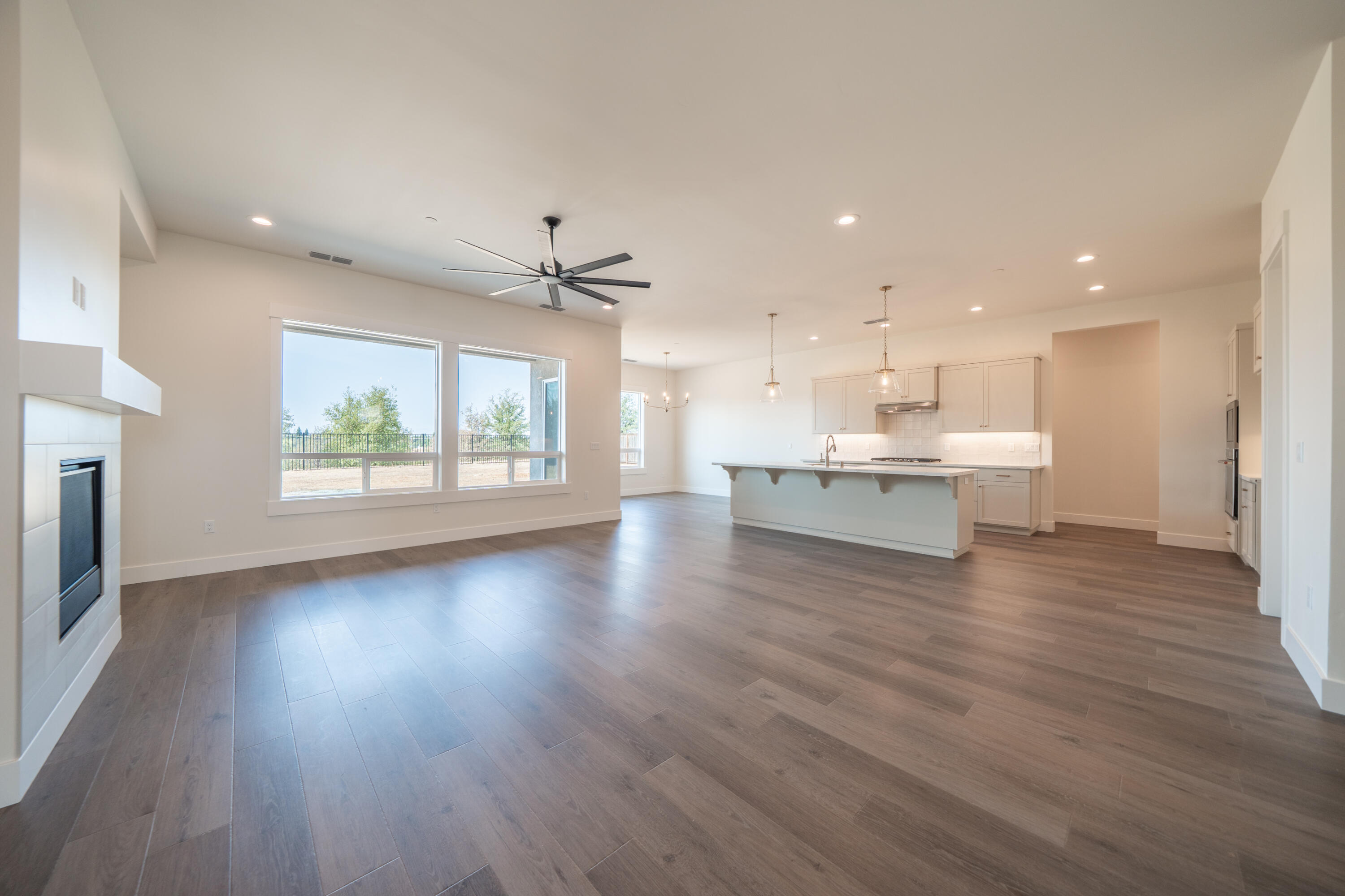 3792 Thomason Trail Redding, CA 96002 - Photo 8 of 42 a view of an empty room with a window and wooden floor