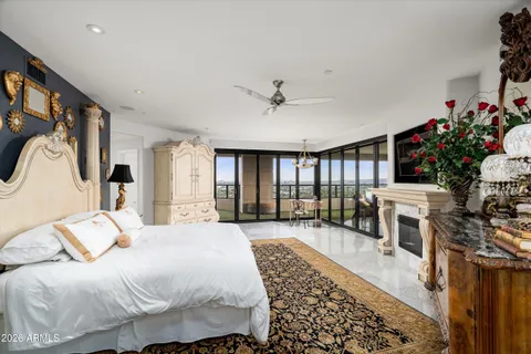 a spacious bedroom with a bed a flat screen tv and a couch