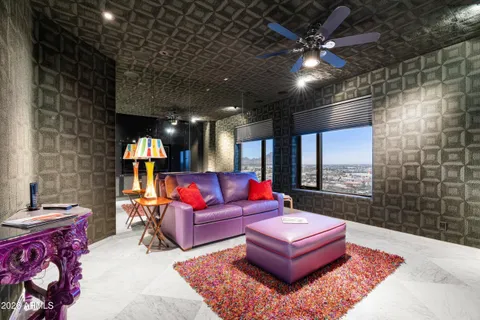 a living room with furniture a rug and a chandelier