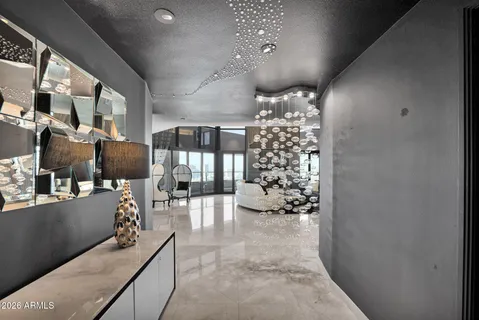 a living room with furniture and a chandelier