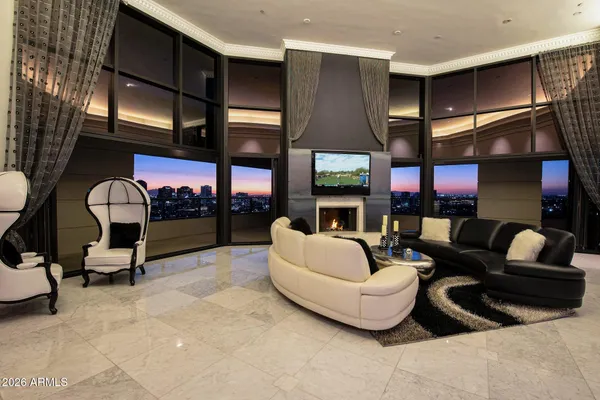 a living room with fireplace furniture and a floor to ceiling window
