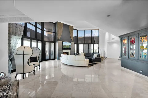 a living room with furniture and large windows
