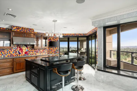 a kitchen filled with a large window and a table