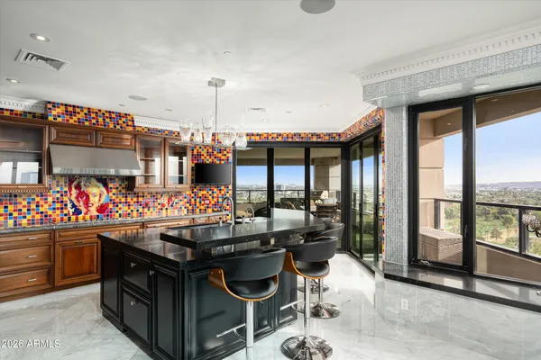 a kitchen filled with a large window and a table