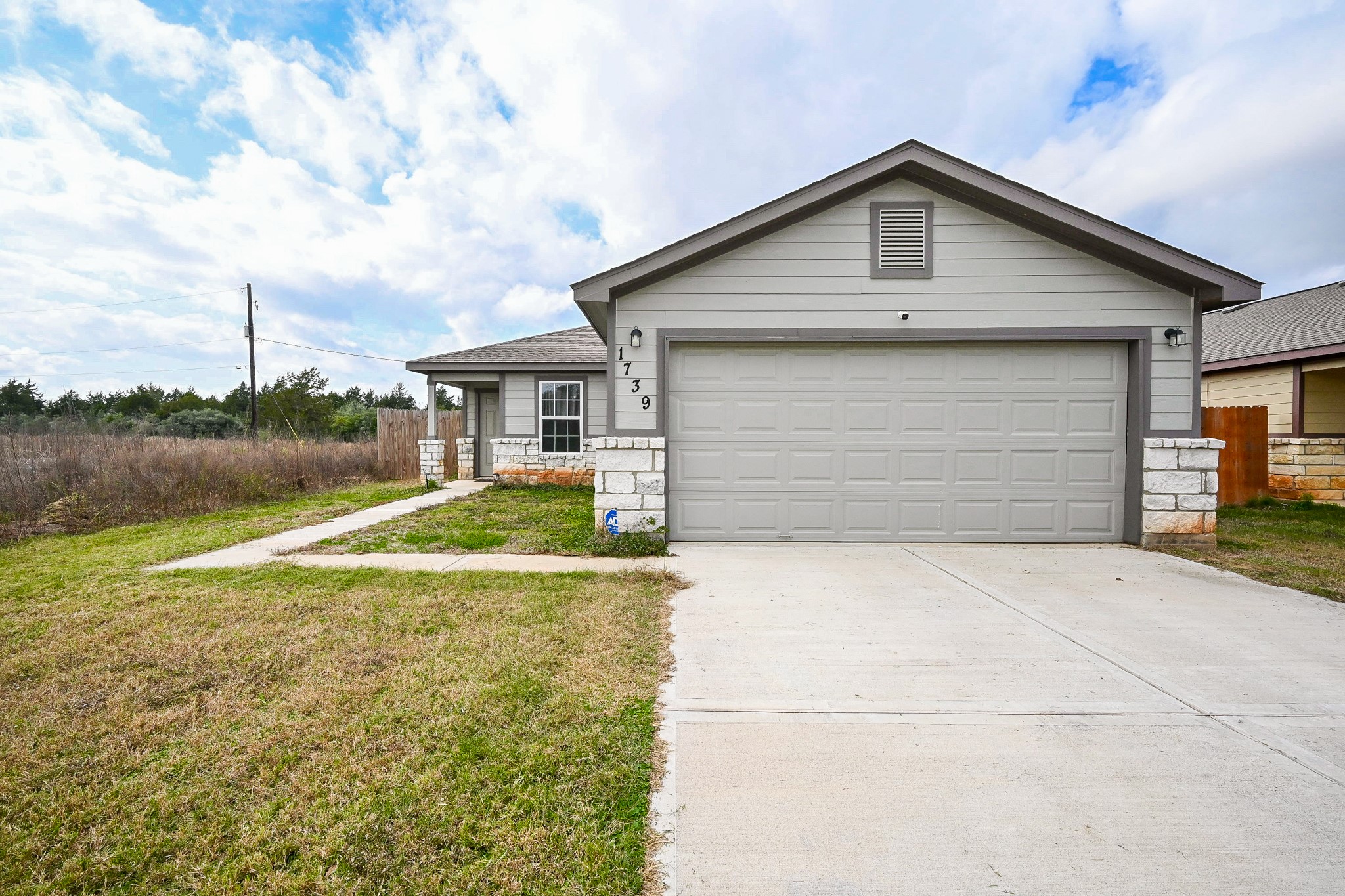 a view of backyard of house with lake view