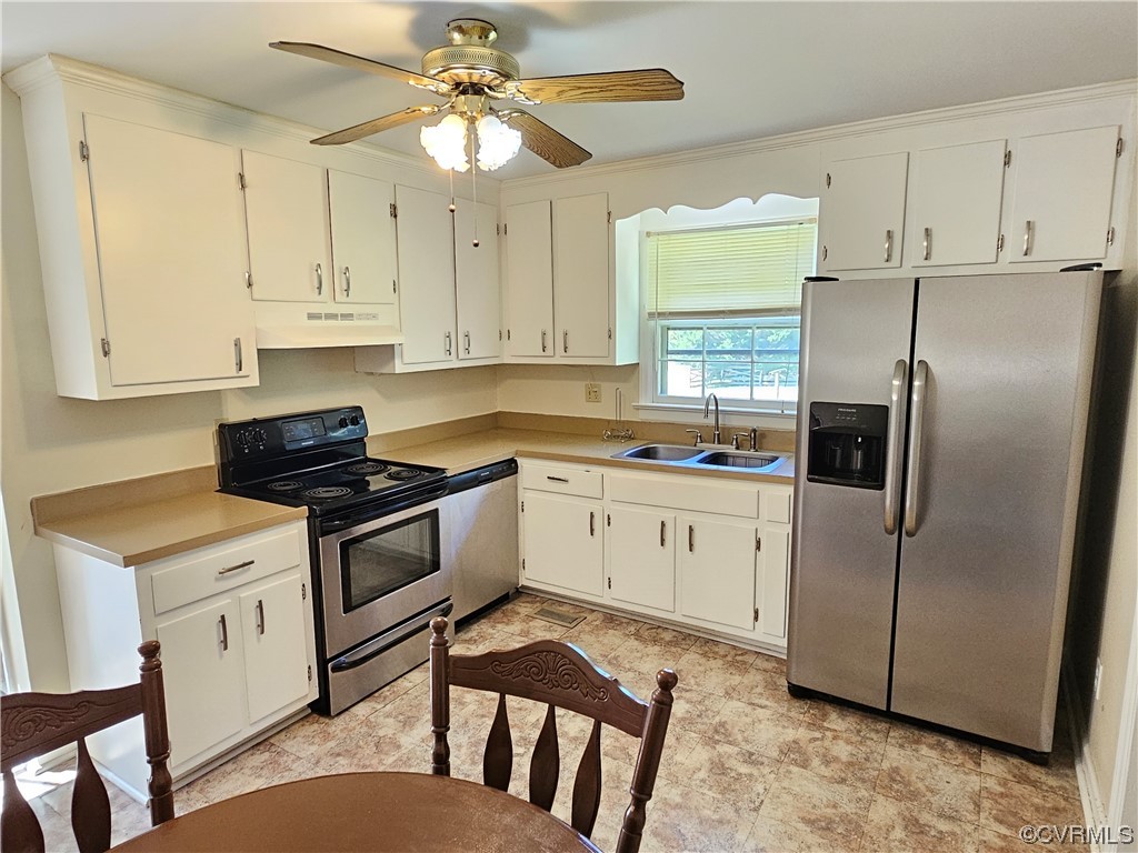 11310 Clement Town Road Amelia Court House, VA 23002 - Photo 13 of 32 a kitchen with stainless steel appliances granite countertop a stove a refrigerator a sink a stove and white cabinets