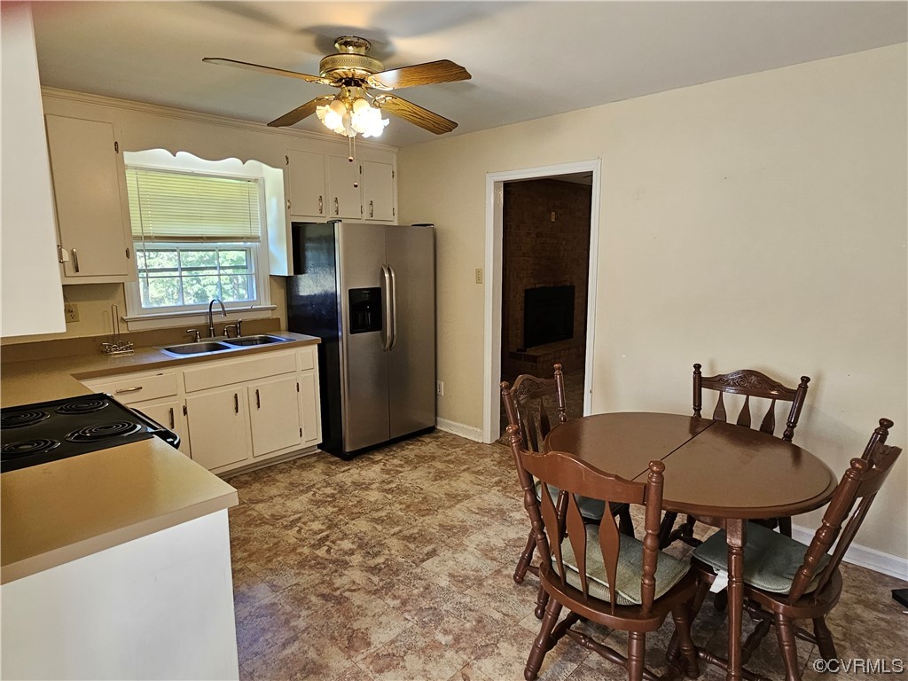 11310 Clement Town Road Amelia Court House, VA 23002 - Photo 14 of 32 a kitchen that has a table chairs and stainless steel appliances