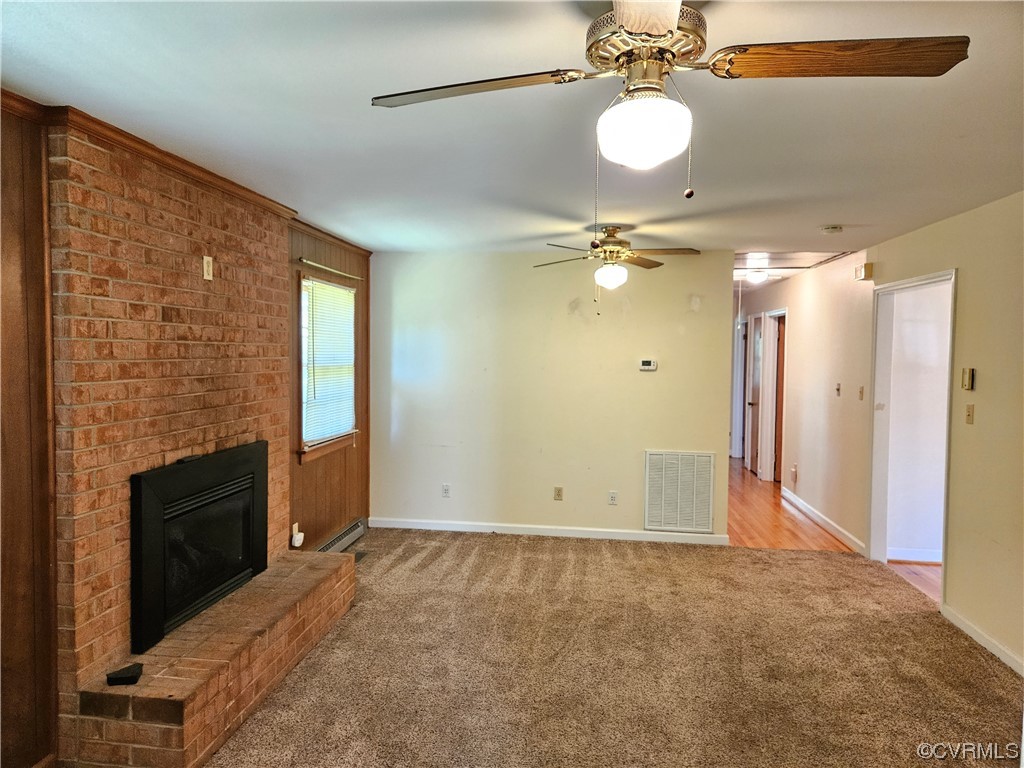 11310 Clement Town Road Amelia Court House, VA 23002 - Photo 16 of 32 a view of a livingroom with a chandelier fan and a fireplace