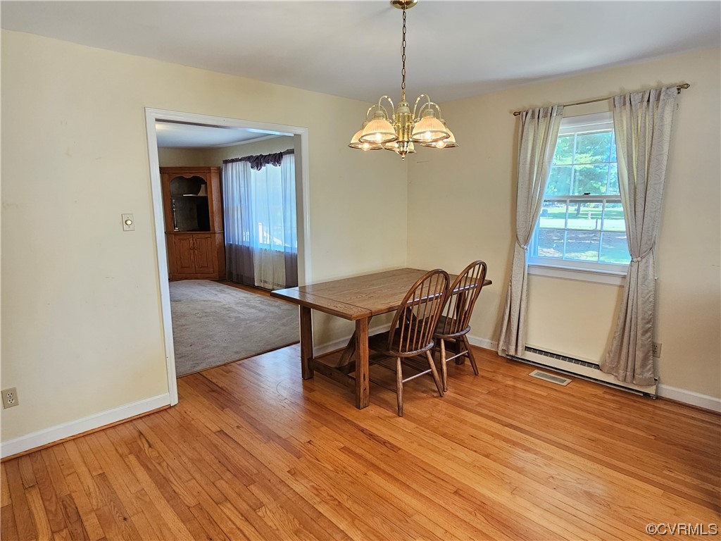 11310 Clement Town Road Amelia Court House, VA 23002 - Photo 18 of 32 a view of a dining room with furniture wooden floor and chandelier