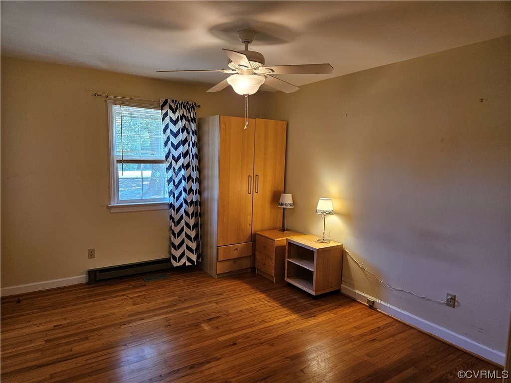 11310 Clement Town Road Amelia Court House, VA 23002 - Photo 27 of 32 a view of an empty room with window and wooden floor