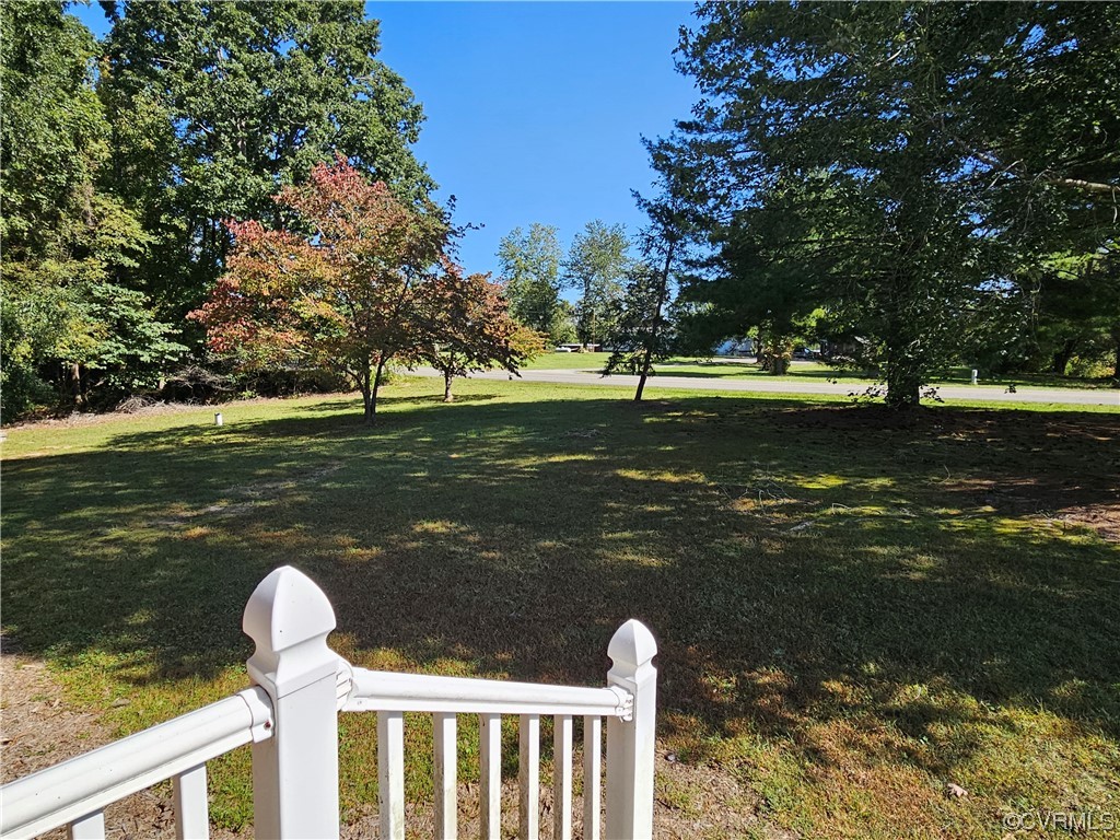 11310 Clement Town Road Amelia Court House, VA 23002 - Photo 6 of 32 a view of a lake with a bench and trees around