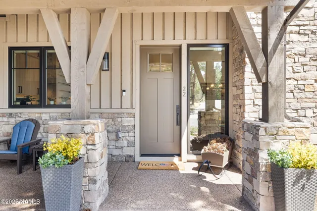a front view of a house with outdoor seating and plants