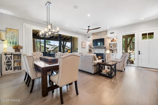a view of a dining room with furniture a chandelier and wooden floor