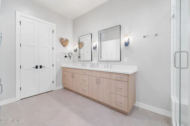 a spacious bathroom with a granite countertop sink a mirror and a