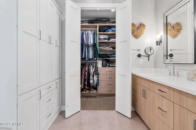 a view of walk in closet with clothes