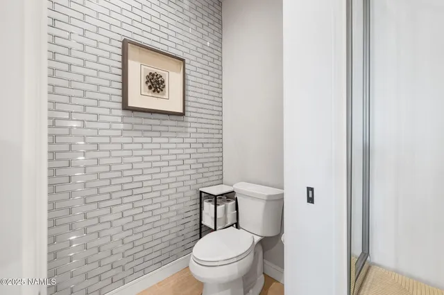 a bathroom with a toilet and a shower curtain