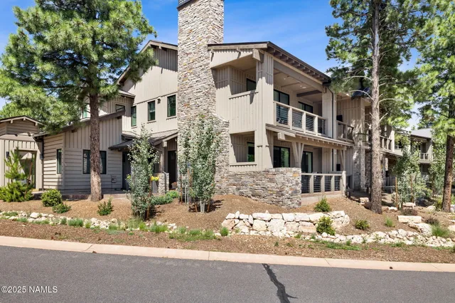 a front view of a building with a yard covered in snow