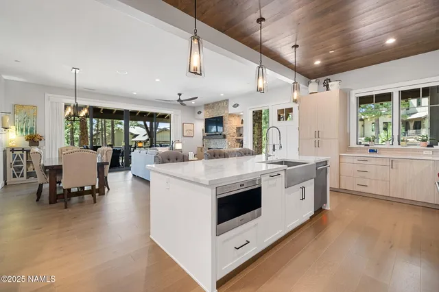 a kitchen with stainless steel appliances granite countertop a sink and a stove