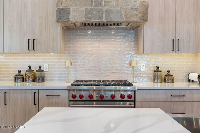 a kitchen with a stove and cabinets