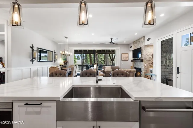 a kitchen with a sink a counter space cabinets and stainless steel appliances